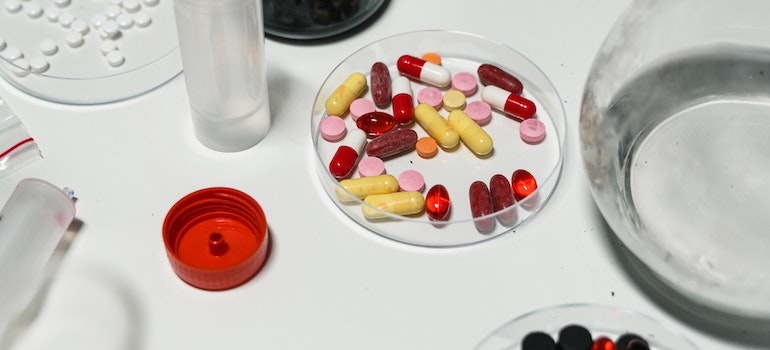Close-Up Shot of Medicines on White Surface