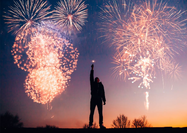 a person celebrating under fireworks, representing celebrating sobriety milestones