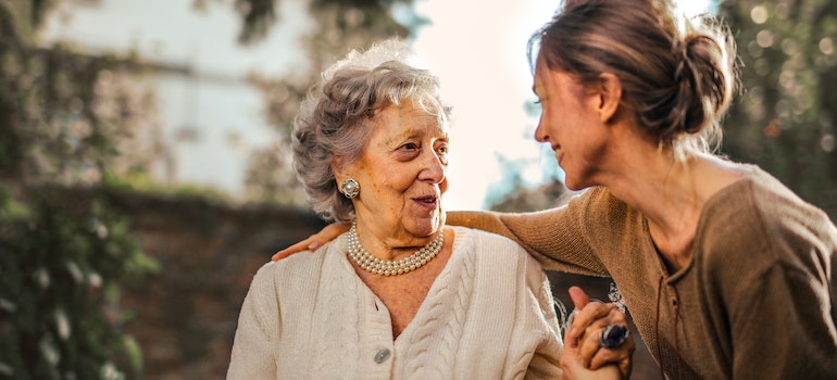 A young woman talking to an elderly woman. 
