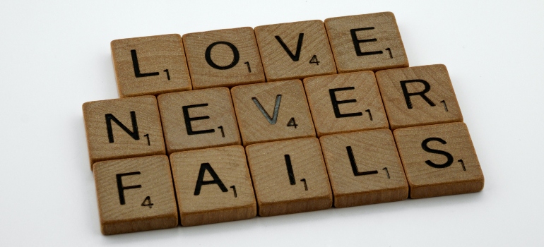 wooden blocks spelling "love never fails"