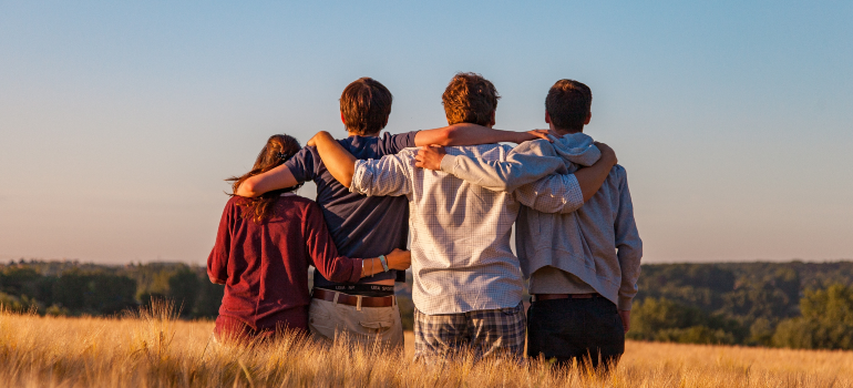 United individuals standing closely, depicting the strength derived from peer support during recovery.